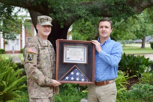 1 LT Joseph Barlow presents a flag and certificate to VP of Operations Luke Allen.