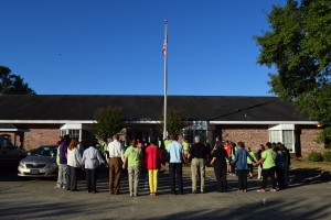 Youth and staff gather around the flagpole in front of Howard School on the Ruston campus.