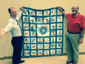 Representing the Children's Home is Doug Hall (left) receiving the quilt from Rev. Chris Blanchard of Covenant UMC.