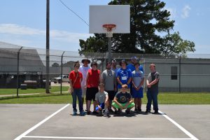 Rebecca with a group of guys who repainted the basketball courts at the Scott Bldg.