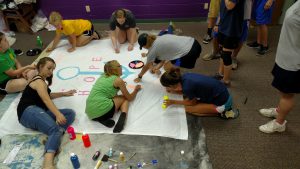 Youth painting a praise banner for our chapel.